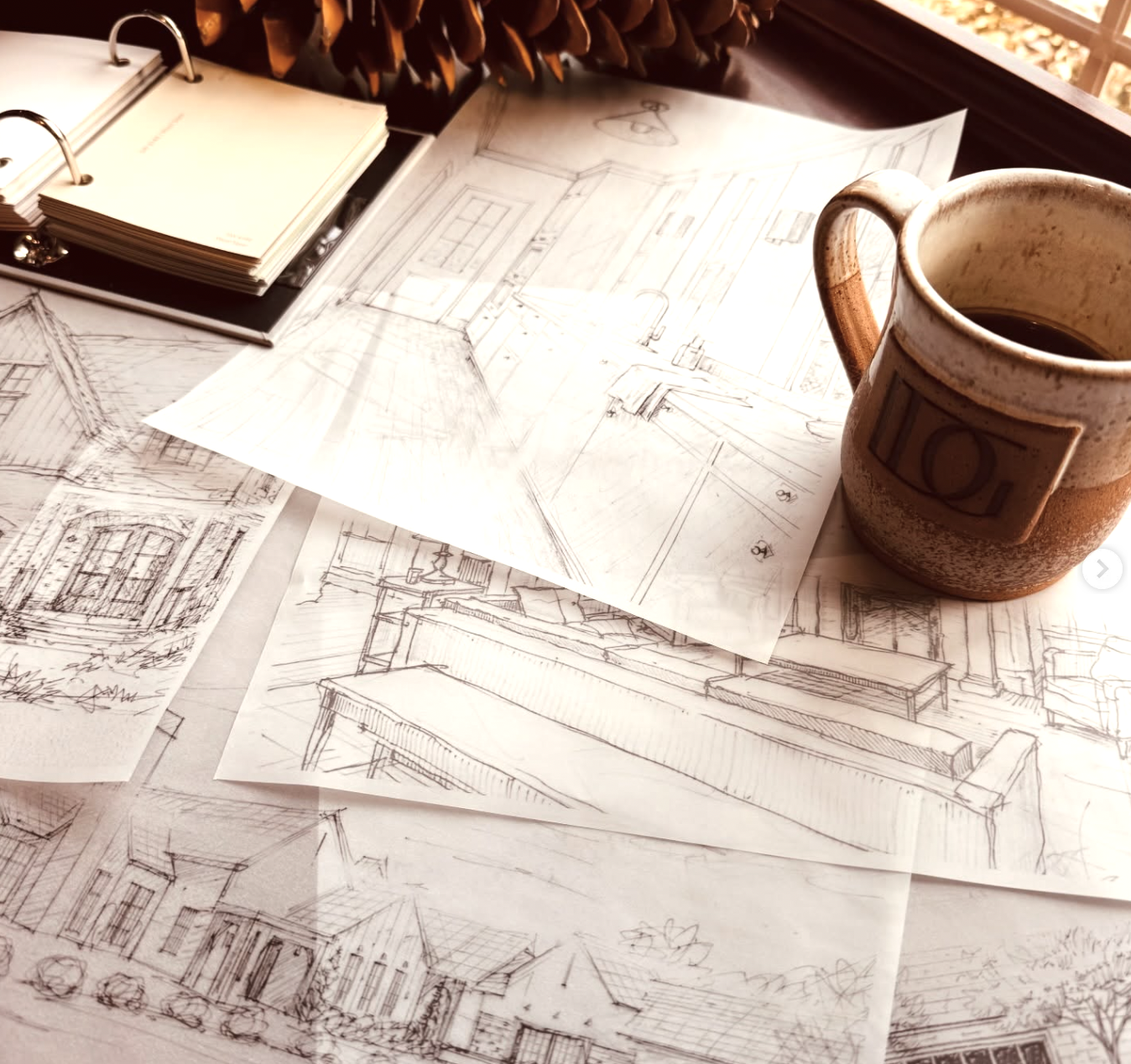 Hand-drawn design plans and sketches on a desk