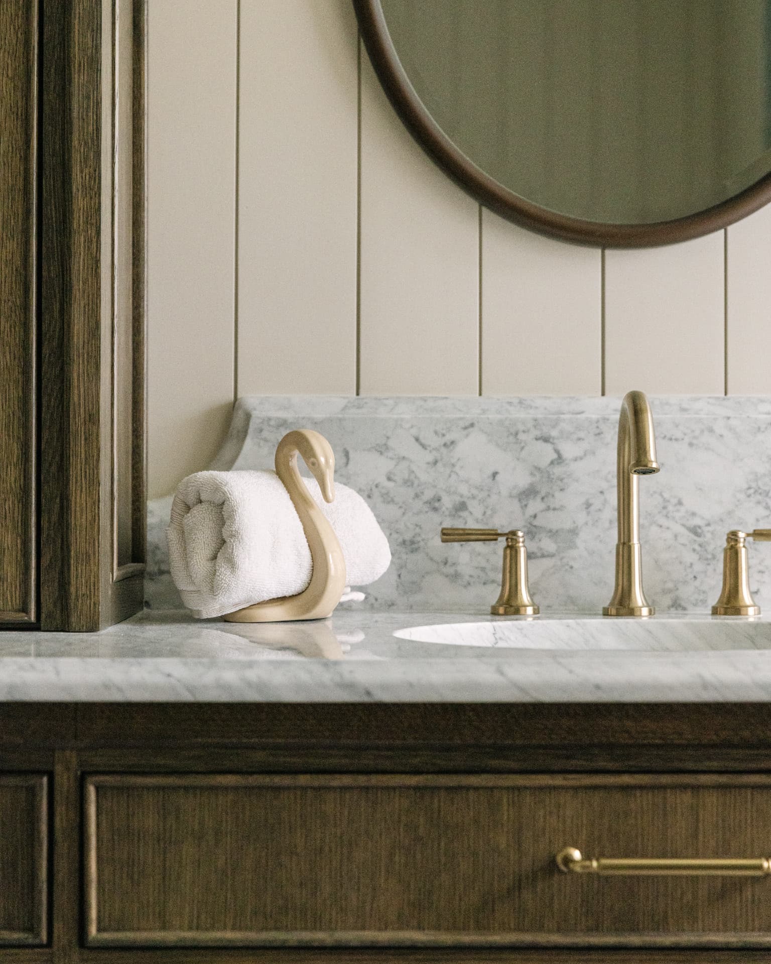 Elegant bathroom vanity with marble and brass details