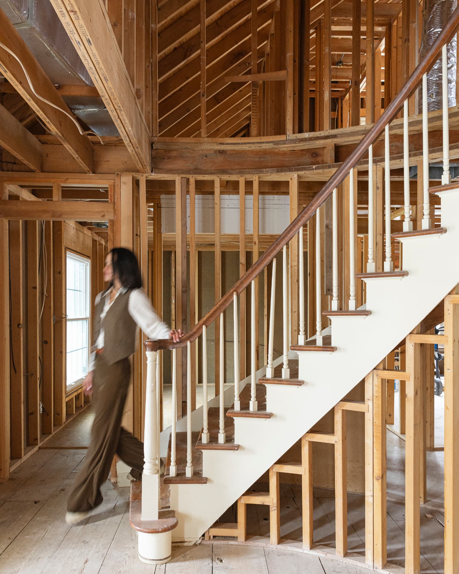 Designer reviewing construction progress on a wooden stairway